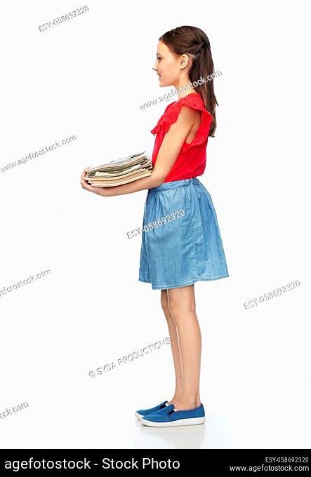 smiling girl with magazines sorting paper waste