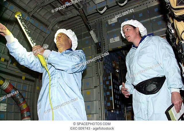 06/08/2002 - STS-107 Mission Specialists Ilan Ramon, with the Israeli Space Agency, and Laurel Clark check out equipment in the SHI Research Double Module...