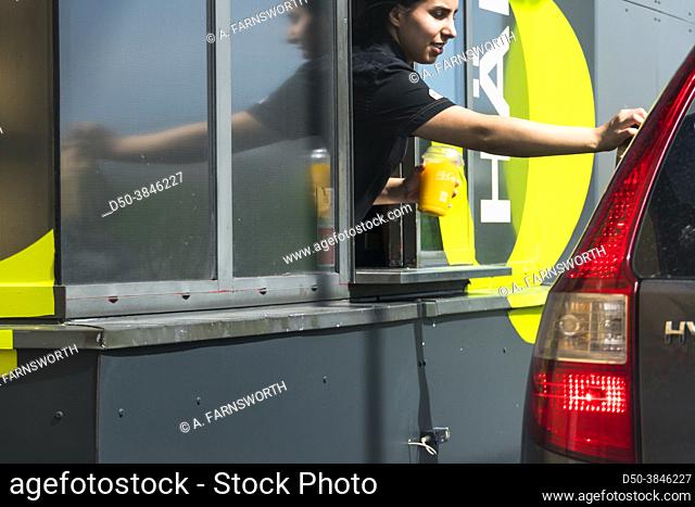 Stockholm, Sweden An attendant hands over food at a Mc Donald's drive-thru window