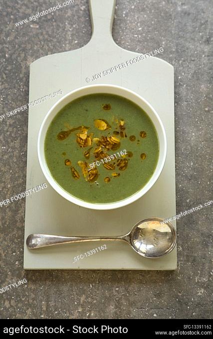 Green vegetable soup with chillied almond garnish