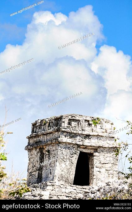 Detail of one of the temples located near the beach in Tulum, Mexico, with some clouds in the background