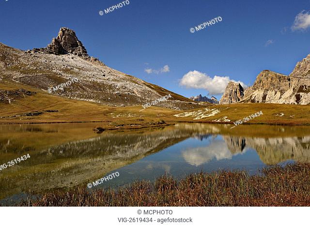 The Toblin Tower, Monte Mattina and part of the Scarperi range reflected in the Bodensee lake in the Sesto Dolomites region of northern Italy