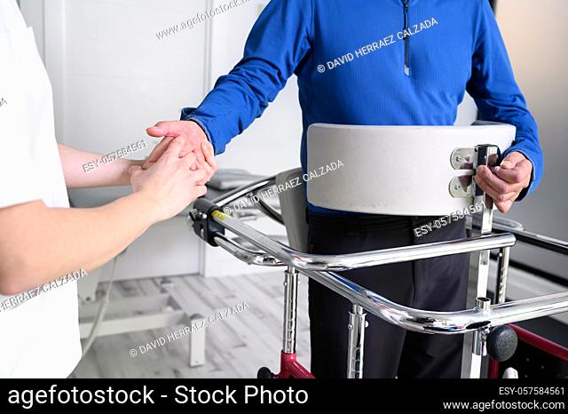 Physiotherapist assisting a patient with Amyotrophic Lateral Sclerosis. High quality photo