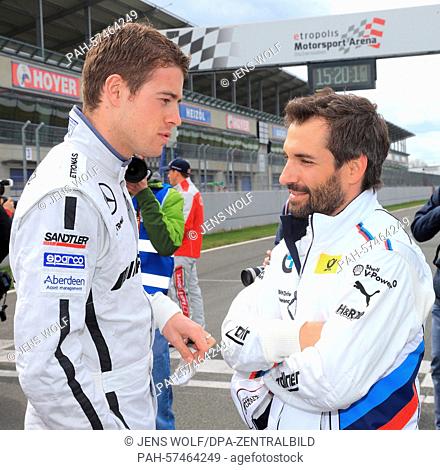 German racing car driver Timo Glock (r) of BMW Team MTEK and British driver Paul Di Resta of Team Mercedes HWA AG talk to each other on the race course during a...