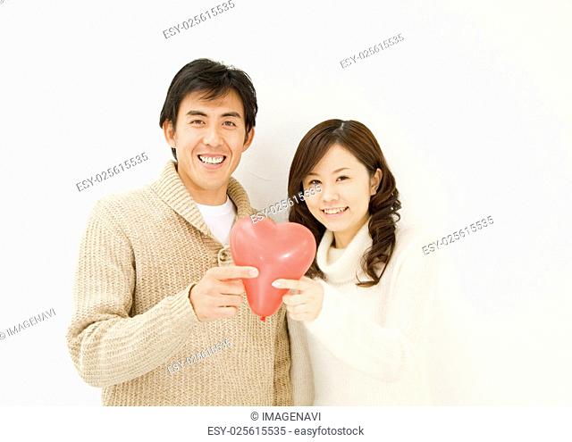 Couple Holding Heart Balloon