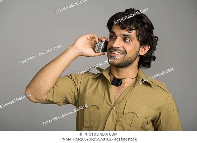 Actor portraying Gabbar Singh talking on a mobile phone