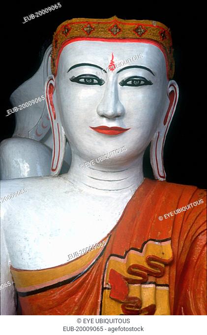 Shwedagon Pagoda. White faced Buddha figure, detail of head and shoulders