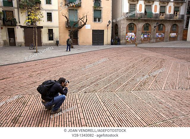 Man taking pictures in Fossar de les Moreres memorial square, Barcelona, Catalonia, Spain