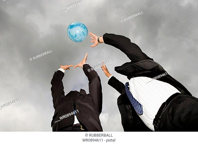 Low angle view of two businessmen playing with a ball