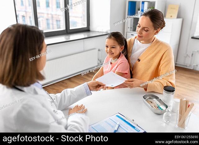 mother with little daughter and doctor at clinic