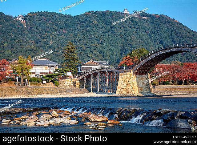 The view of the historical wooden Kintai arch bridge over Nishiki river and Iwakuni Castle on mount in the fall, Iwakuni, Yamaguchi prefecture, Japan