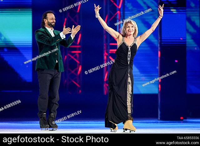 RUSSIA, MOSCOW - DECEMBER 17, 2023: Russian ice dancer Irina Lobacheva (R) performs as Russian ice dancer Ilya Averbukh claps his hands during an ice show...