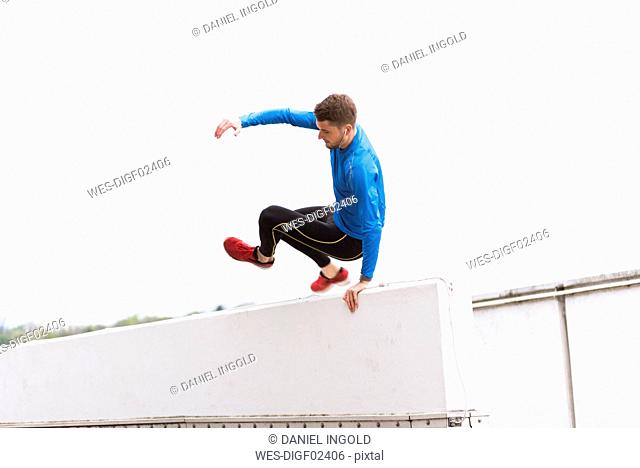 Young athlete crossing a wall