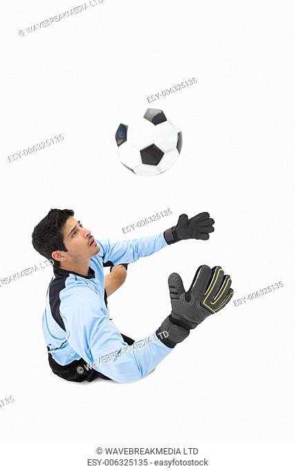 High angle view of goal keeper in action over white background