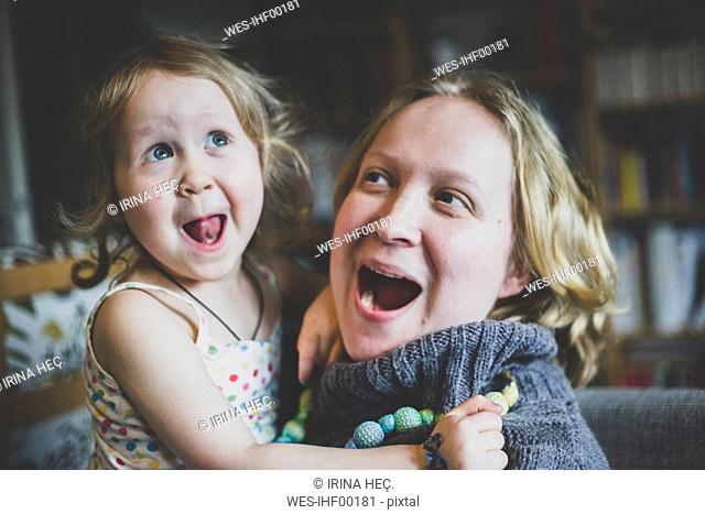 Portrait of mother and little daughter having fun together at home