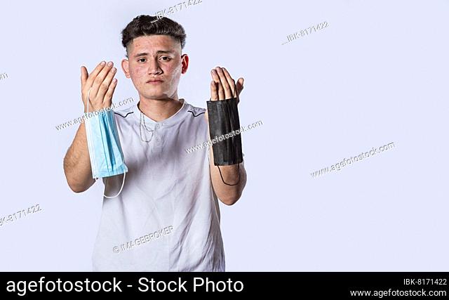 Man showing two surgical mask, handsome young man offering surgical mask on isolated background