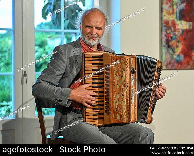 24 June 2022, Brandenburg, Neuhardenberg: Musician Tobias Morgenstern plays his accordion, recorded during a vernissage at Neuhardenberg Castle