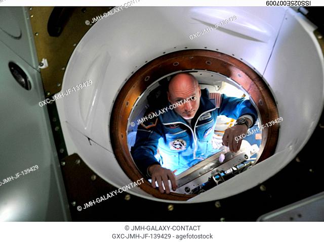NASA astronaut Scott Kelly, Expedition 25 flight engineer, is pictured inside the hatch area of the Soyuz TMA-01M spacecraft on docking day with the...