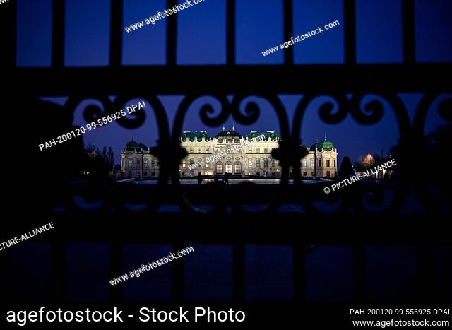 19 January 2020, Austria, Wien: View in the evening through the entrance gate to the Belvedere Palace in the baroque gardens