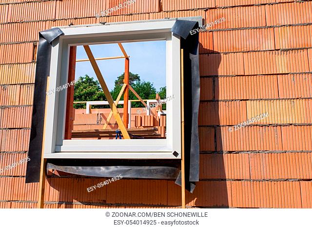 Construction site with window frame in wall