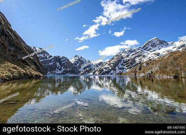 Mountains reflected in lake, Lake Harris, Conical Hill, Routeburn Track, Mount Aspiring National Park, Westland District, West Coast, South Island, New Zealand