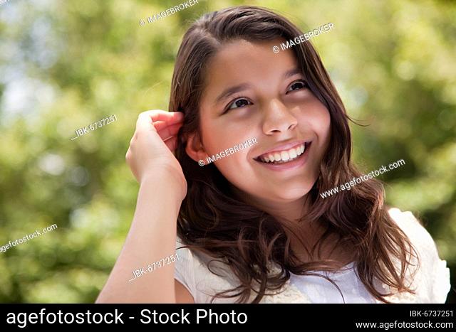 Cute happy hispanic girl in the park