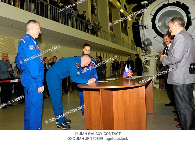 At the Gagarin Cosmonaut Training Center in Star City, Russia, Expedition 41 Flight Engineer Barry Wilmore of NASA (center) signs in at the start of final...