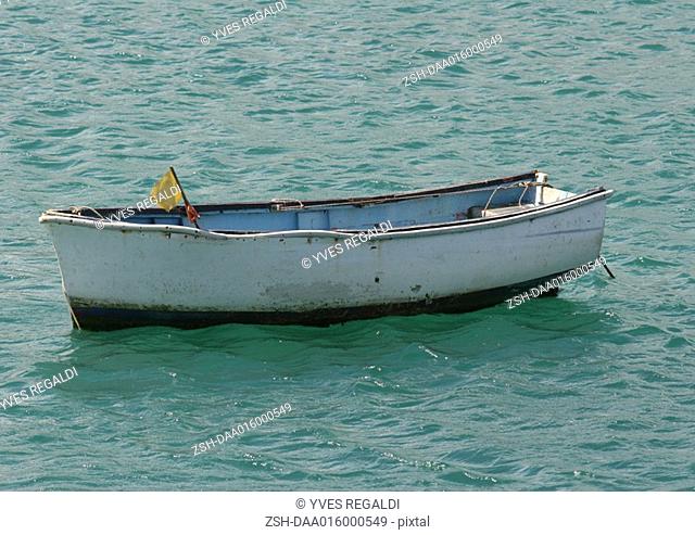 Empty rowboat in water