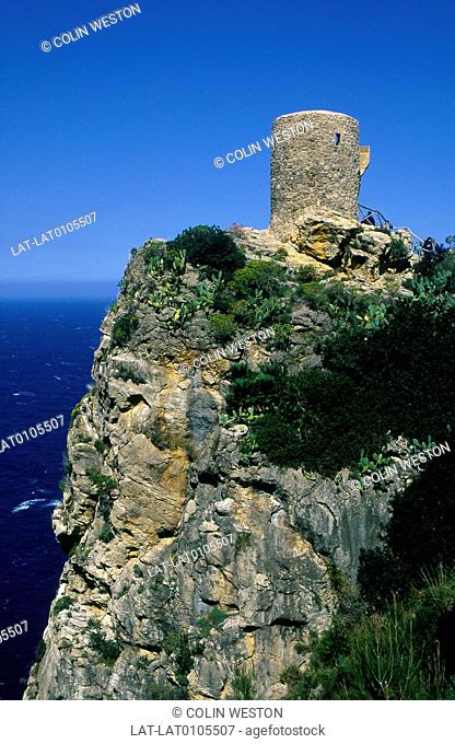 Majorca. Coast. Steep sheer cliffs. Sea. Round watchtower, talaia de Ses Animes. View