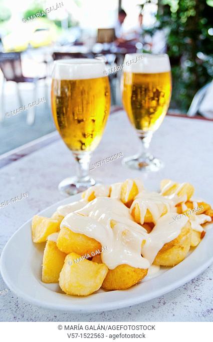 Spanish appetizer: Patatas alioli and two glasses of beer in a terrace. Madrid, Spain