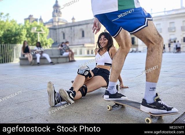 Two young people riding on skateboards in the city