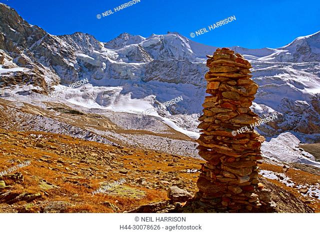 The Zinalrothorn with a cairn in the foreground, in the Southern Swiss Alps above Zinal