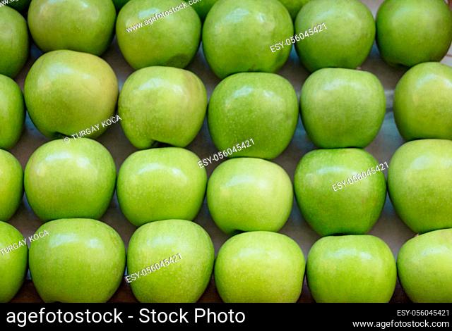 Green apples in a market place in display