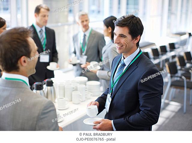 Business people drinking coffee in office