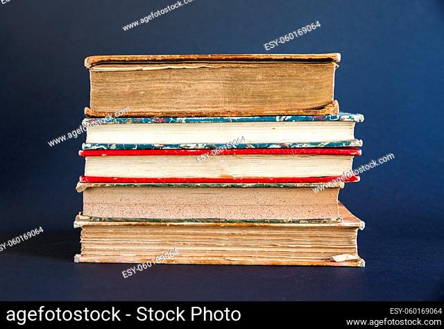 Stack of old books isolated on dark background