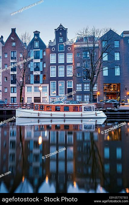 Amsterdam canals in the evening light, Dutch canals in Amsterdam Holland Netherlands during winter time in the Netherlands. Europe