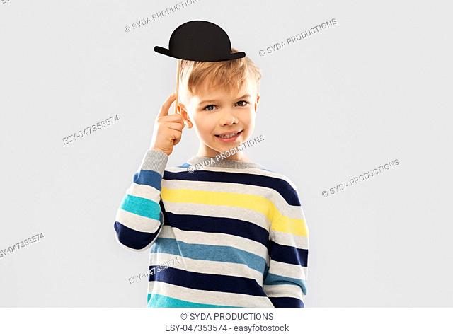 smiling boy with black vintage bowler hat