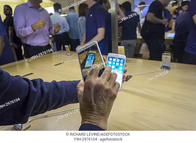 A customer in the Apple store in Grand Central Terminal in New York photographs the new iPhone 8 plus with an iPhone 8 on Friday, September 22, 2017