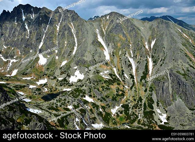 Landscape in the High Tatras with mountains, the valley Mlynicka dolina, the lake Pleso nad Skokom and the waterfall Vodopad Skok. Slovakia