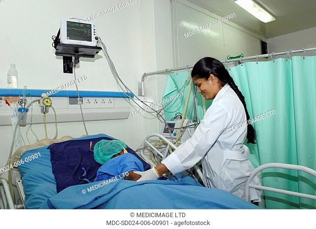 This patient is receiving intravenous IV fluids into his right arm and oxygen via a nasal cannula. He wears a pulse oxymeter on his right index finger