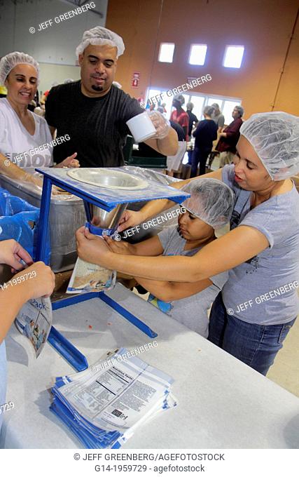 Florida, Miami, Miami-Dade County Fair And Expo, Feed My Starving Children, volunteer, community service, packing, meals, Hispanic, man, father, woman, mother