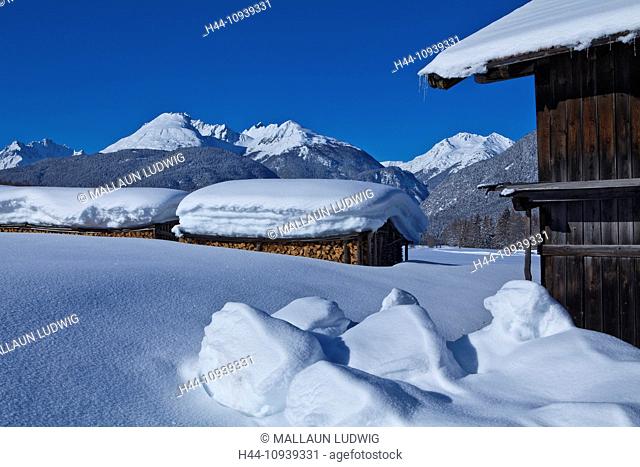 Austria, Europe, Tyrol, Mieminger plateau, Obsteig, Holzleiten, winter, snow, wooden pile, Stadel, mountains, Lechtal, Lech valley, Alps, sky, blue, width