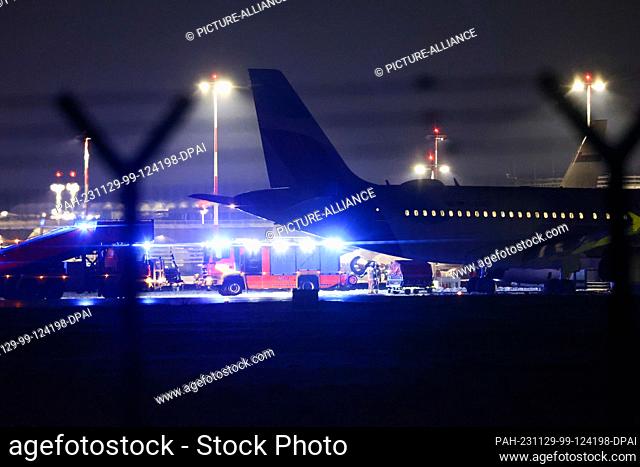 29 November 2023, Hamburg: A Eurowings aircraft is parked away from the terminals at Hamburg Airport. According to media reports