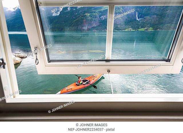 Boy kayaking seen from the window