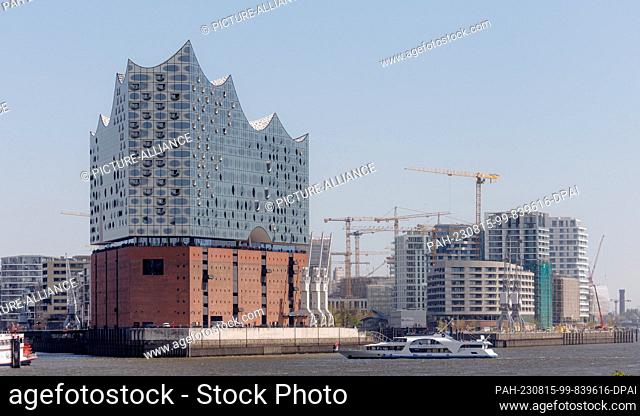 10 May 2023, Hamburg: View across the Elbe to the Elbphilharmonie concert hall and the new Strand-Quartiere development project in Hafencity