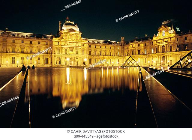 Grand Louvre art museum and Cour Napoleon by night, Paris. France