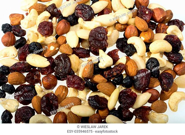 mixed nuts and dried fruits isolated on white background