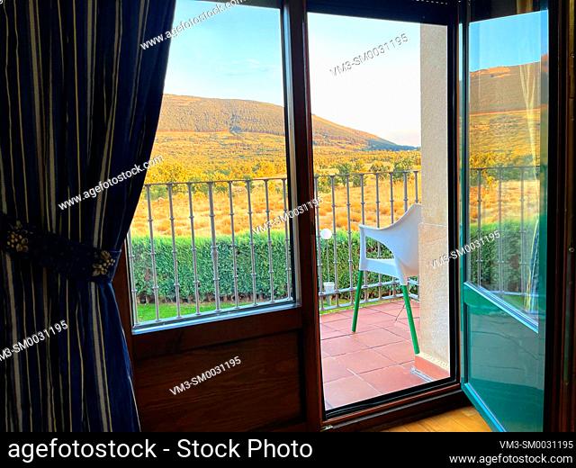 Landscape viewed trough an open balcony. Cerezo de Arriba, Segovia province, Spain
