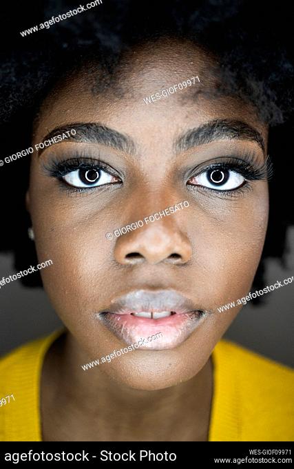 Close-up of young woman face with circle flash reflection in eyes