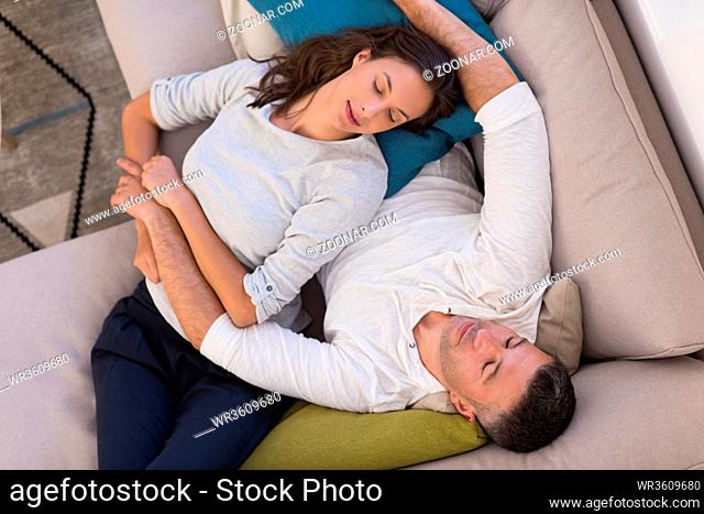 top view of Young couple on the sofa watching television together in their luxury home